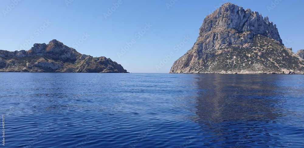 Views of the island of Es Vedrà from a kayak.