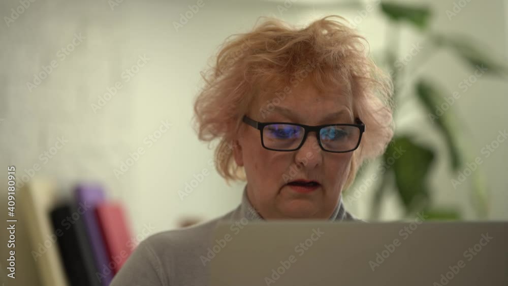 Video call. Good-looking elderly lady i having a video call on laptop Video call. Good-looking elderly lady i having a video call on laptop