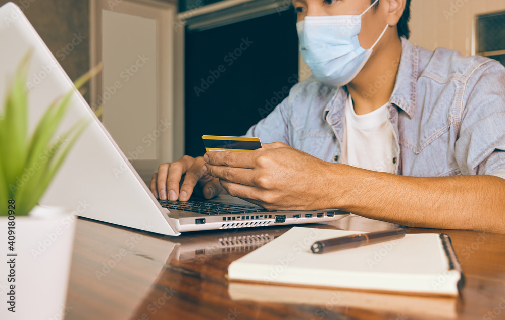 Zoom View Casual Businessman in Denim or Jeans Shirt Wear Face Mask Using Credit Card and Laptop for Online Payment in Coffee Shop. Casual Businessman with Technology in Covid 19 Situation Zoom View Casual Businessman in Denim or Jeans Shirt Wear Face Mask Using Credit Card and Laptop for Online Payment in Coffee Shop. Casual Businessman with Technology in Covid 19 Situation