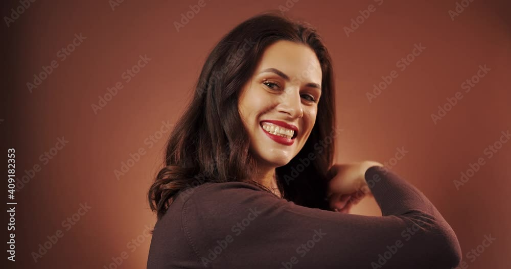 beautiful woman poses in studio on brown background beautiful woman poses in studio on brown background