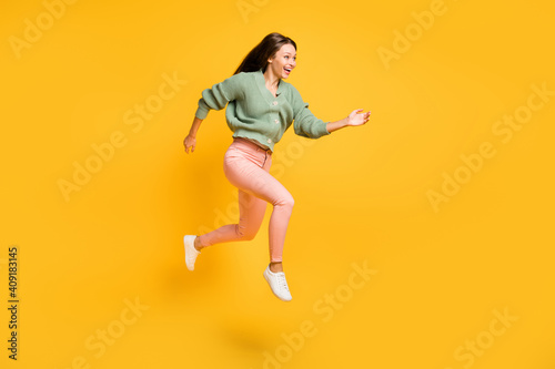 Full size profile side photo of young happy excited crazy girl run in air look copyspace isolated on yellow color background