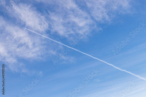 High white cirrus clouds with cirro-stratus in a light blue sky, sometimes called chair tails, indicate nice weather, but stormy changes come within a few days. Chemtrails on a blue sky