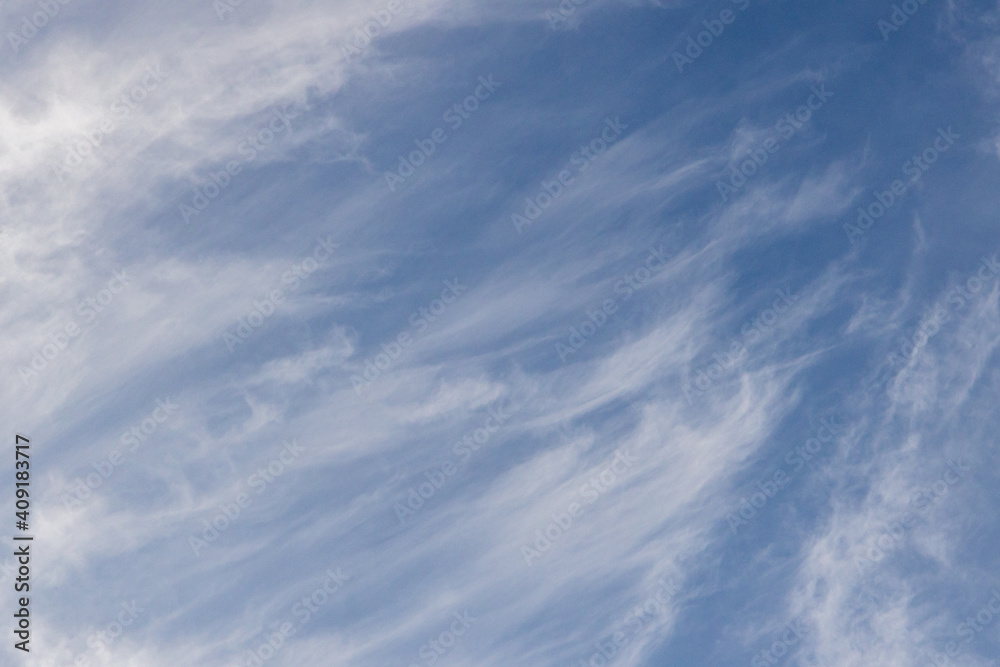 High white cirrus clouds with cirro-stratus in a light blue sky, sometimes called chair tails, indicate nice weather, but stormy changes come within a few days. White clouds in a blue sky. 