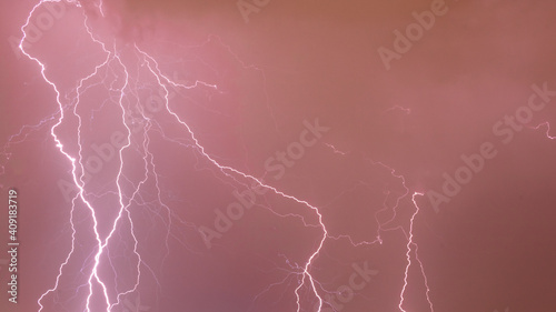 Lightnings in the clouds. Strong storm background photo. Weather banner background. Thunderbolt and flash long exposure shoot. 