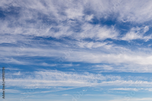 High white cirrus clouds with cirro-stratus in a light blue sky, sometimes called chair tails, indicate nice weather, but stormy changes come within a few days. White clouds in a blue sky. 