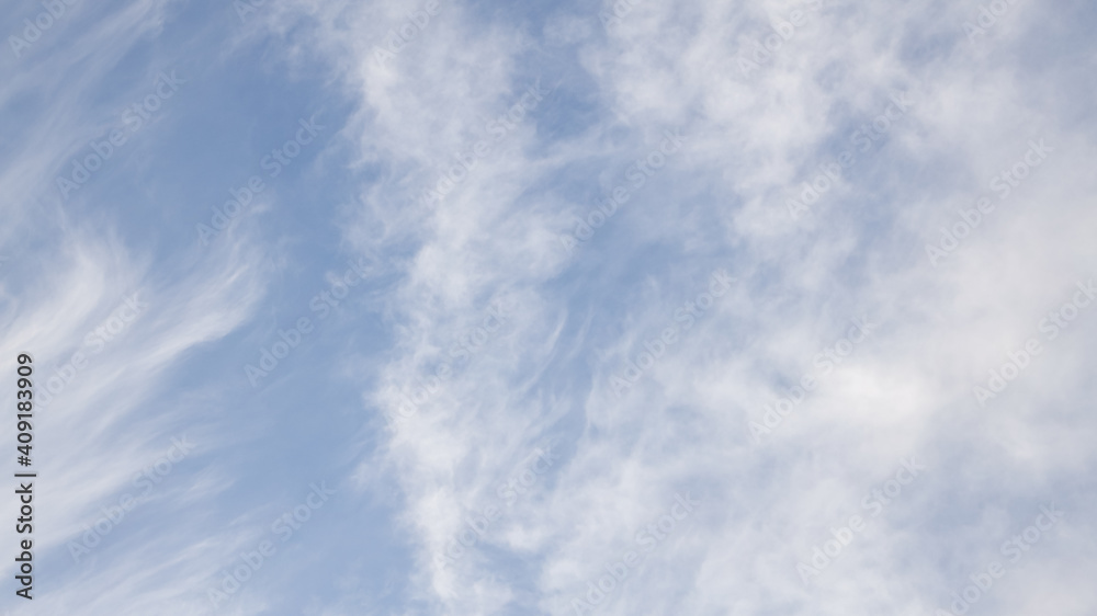 High white cirrus clouds with cirro-stratus in a light blue sky, sometimes called chair tails, indicate nice weather, but stormy changes come within a few days. White clouds in a blue sky. 