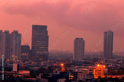 The high angle background of the city view with the secret light of the evening  blurring of night lights  showing the distribution of condominiums  dense homes in the capital community