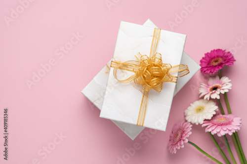 Gifts and flowers on pastel pink background. Happy Mother's Day, Women's Day, Valentine's Day or Birthday Background
