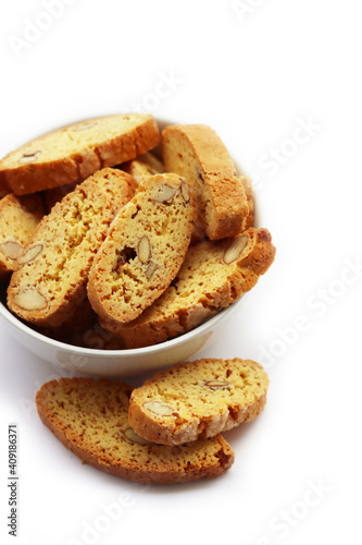 Traditional Italian Cantucci or Cantuccini cookies with almonds in a bowl isolated on white background