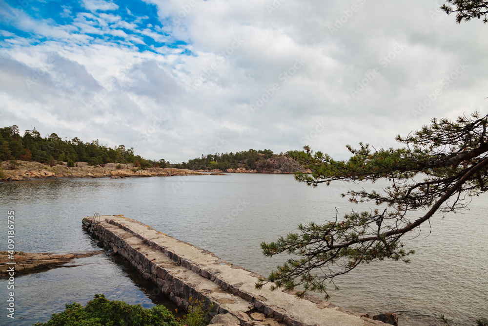 lake in the forest. Small jetty on a lake. Lake in Sweden. Travel in Sweden. Landing stage. concrete footbridge lake in the forest. Small jetty on a lake. Lake in Sweden. Travel in Sweden. Landing stage. concrete footbridge
