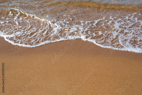 Fototapeta Naklejka Na Ścianę i Meble -  Sand on the beach with a sea wave
