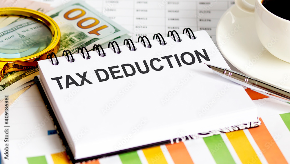 TAX DEDUCTION text.Top view office table, Business graph show for