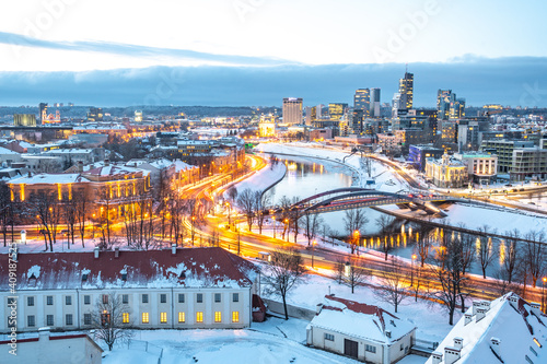 Vilnius, capital of Lithuania, beautiful scenic aerial panorama of modern business financial district architecture buildings with river and bridge in winter