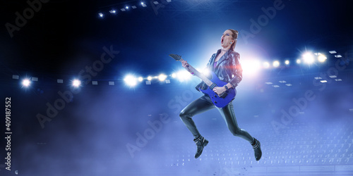 Young and beautiful rock girl playing the electric guitar © Sergey Nivens