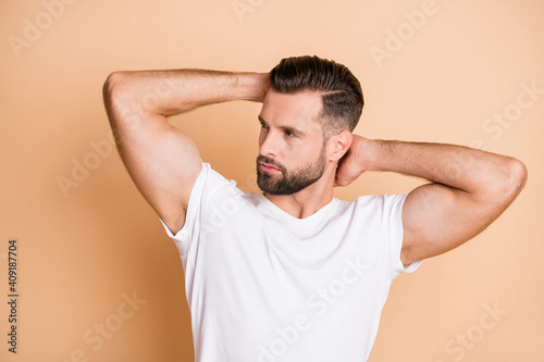 Profile side photo of young handsome bristle man look empty space new haircut hairdo isolated over beige color background