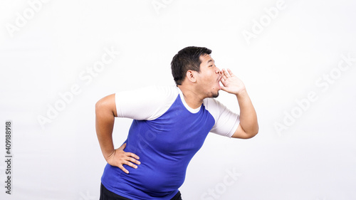 Portrait of funny young Asian man shouting and yelling