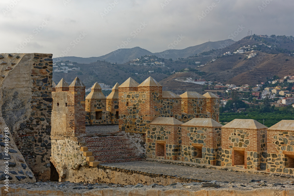 The view from the partially restored Fort and City walls of the Citadel at the small Spanish Coastal town of Almunica, with the Mountain Villages in the background.