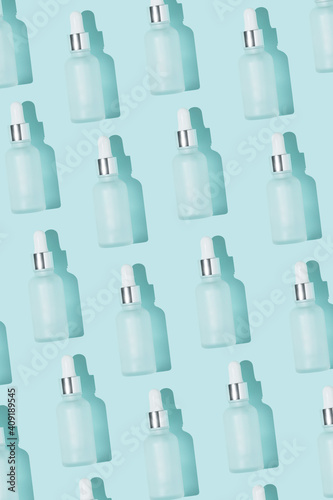 Dropper bottle pattern vertical photo on the blue background backdrop minimal design white top