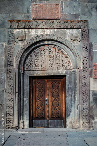 Geghard, Armenia - January 17, 2021: Beautiful portal in Geghard monastery in Armenia, decorared with traditional Armenian ornaments