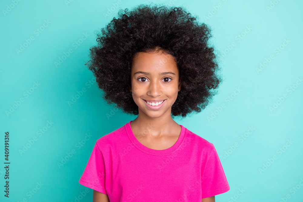 Photo portrait of smiling afro american girl isolated on vivid cyan colored background