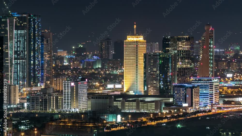 Dubai downtown skyline timelapse at night. Top view of Sheikh Zayed road with numerous illuminated towers and skyscrapers. Traffic on the road in financial district. Famous landmark Dubai downtown skyline timelapse at night. Top view of Sheikh Zayed road with numerous illuminated towers and skyscrapers. Traffic on the road in financial district. Famous landmark