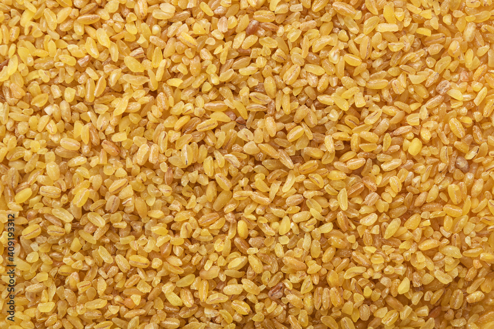 Top view of uncooked organic bulgur grains.Bulgur Wheat Background. Top view of uncooked organic bulgur grains.Bulgur Wheat Background.