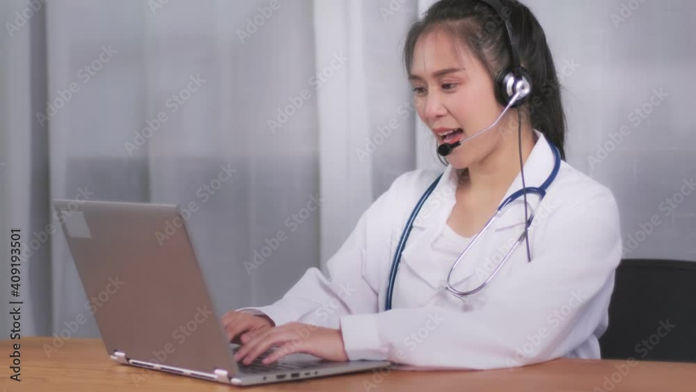 Medical healthcare professional expert Asian female doctor online video call microphone talking with patient examine giving advice diagnosing illness, at hospital office working coronavirus covid-19 Medical healthcare professional expert Asian female doctor online video call microphone talking with patient examine giving advice diagnosing illness, at hospital office working coronavirus covid-19