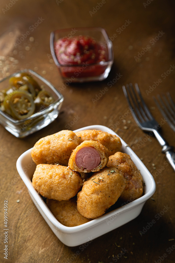 Mini corn dog with ketchup and jalapeno pepper Mini corn dog with ketchup and jalapeno pepper