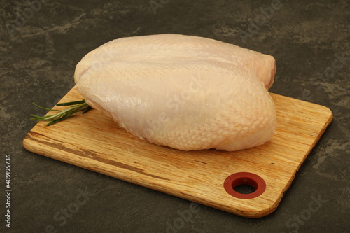 Raw whole chicken breast with skin