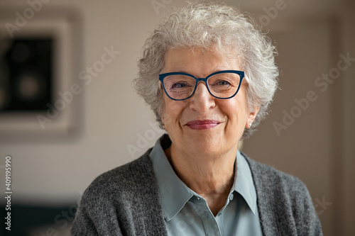Senior smiling woman with spectacles looking at camera photo