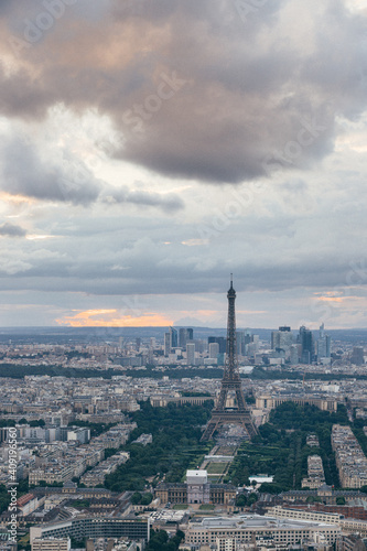 Sunset landscapes of the Paris skyline, view of the Eiffel Tower from the Tour Montparnasse in a cloudy day © Sen