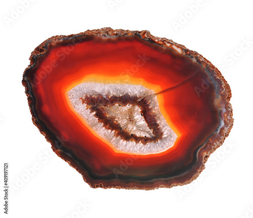 Thin polished red slice of agate geodes with concentric layers isolated over a white background