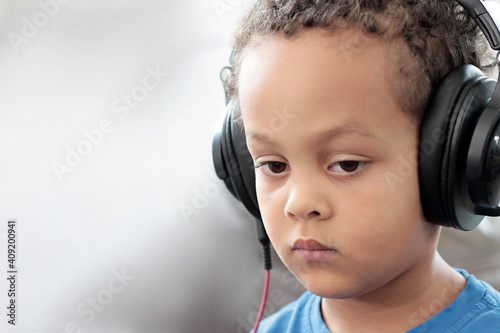 child with headphones enjoying music on white background stock photo 