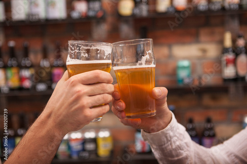 Unrecognizablemen clinking beer glasses