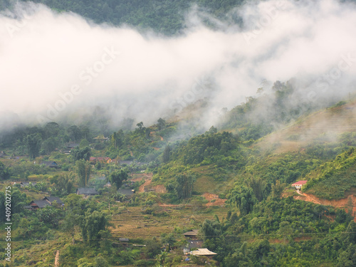 Landscape with a village in the surroundings of Sa Pa in Lào Cai Province in north-west Vietnam on a foggy day