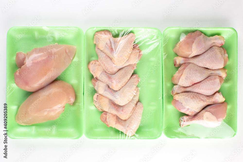 Raw chicken parts in green plastic container Raw chicken parts in green plastic container