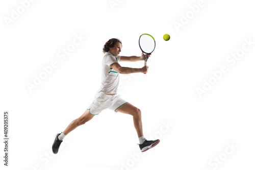 Jumping. Young caucasian professional sportsman playing tennis isolated on white background. Training, practicing in motion, action. Power and energy. Movement, ad, sport, healthy lifestyle concept. © master1305