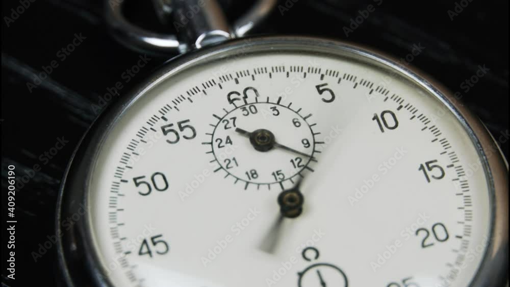 A stopwatch on a dark wooden table. A tool for measuring time. Macro photography. An old vintage stopwatch, the hand is moving. timelapse, A stopwatch on a dark wooden table. A tool for measuring time. Macro photography. An old vintage stopwatch, the hand is moving. timelapse,