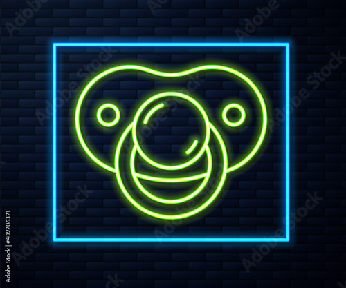 Glowing neon line Baby dummy pacifier icon isolated on brick wall background. Toy of a child. Vector.
