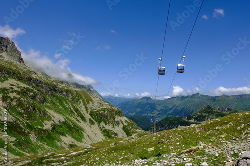 cable car with two gondolas next to each other in the mountains
