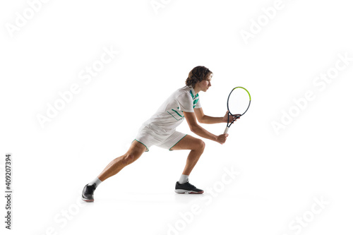 Aspiration. Young caucasian professional sportsman playing tennis isolated on white background. Training, practicing in motion, action. Power and energy. Movement, ad, sport, healthy lifestyle concept © master1305