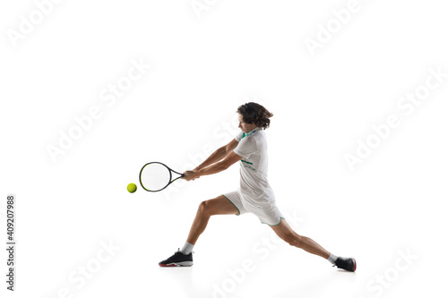 Achievement. Young caucasian professional sportsman playing tennis isolated on white background. Training, practicing in motion, action. Power and energy. Movement, ad, sport, healthy lifestyle © master1305
