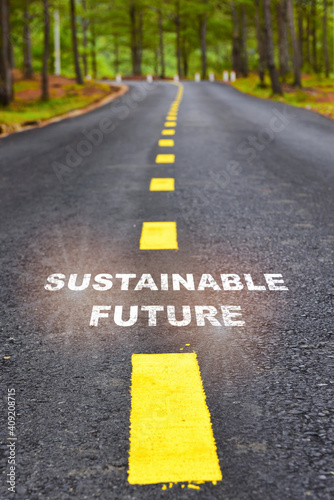 Sustainable future word on asphalt road surface with marking lines. Clean energy with inspiration and motivation concept and effort with keep moving idea