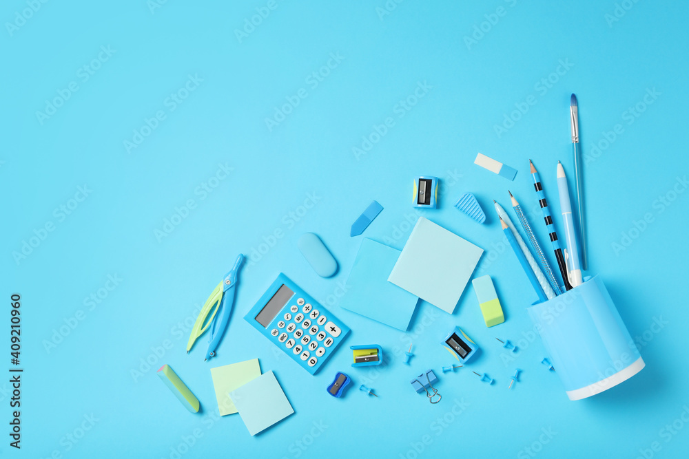 Different stationery on light blue background, flat lay with space for text. Back to school