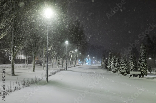 city park on a winter night, beautiful decorative lighting, strong cold snowstorm without people © evgavrilov