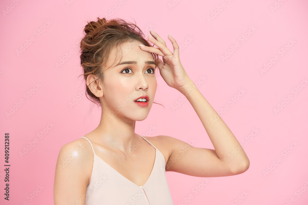 beauty portrait of sad woman touching her skin on pink background beauty portrait of sad woman touching her skin on pink background