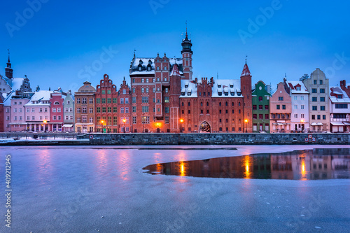 Old town of Gdansk over Motlawa river at snowy dawn. Poland
