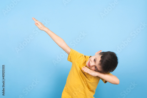 a child celebrates victory with a hand gesture to the sky