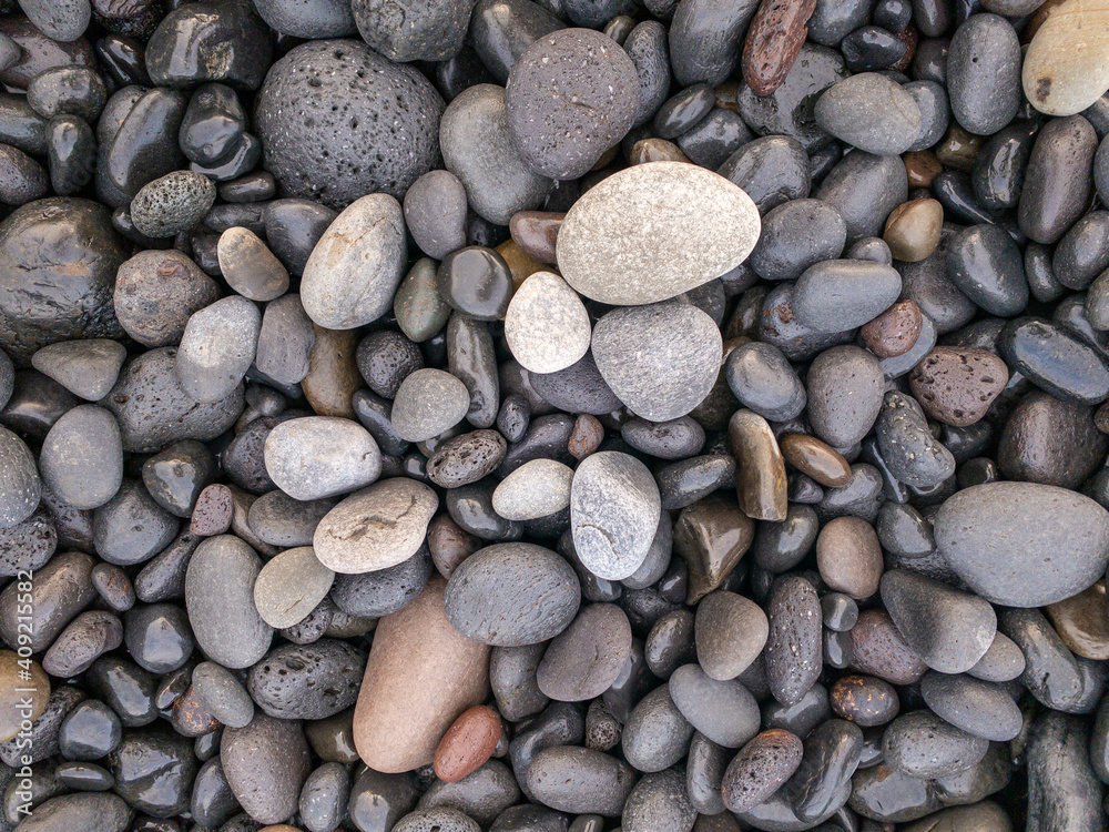 Different colors of pebbles on Reunion island east sea shore