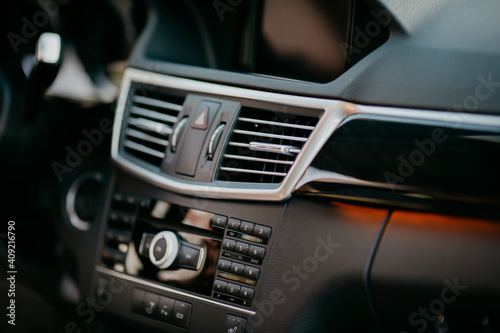 adjustable ventilation grille on dashboard of modern car. © kucheruk